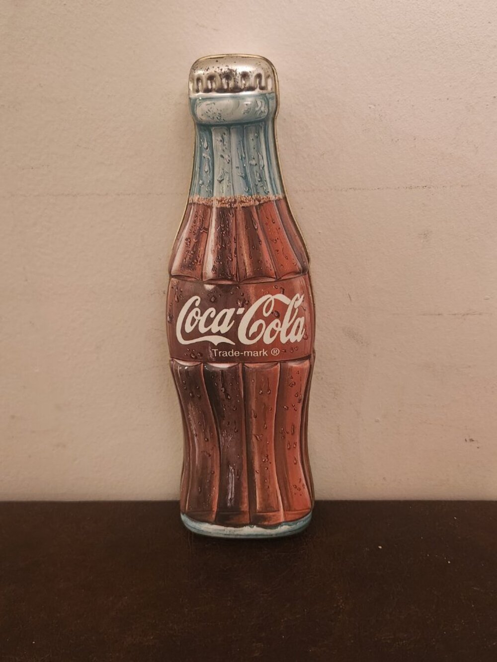 Vintage Coca Cola Bottle Tin stands at 9.5 inches tall